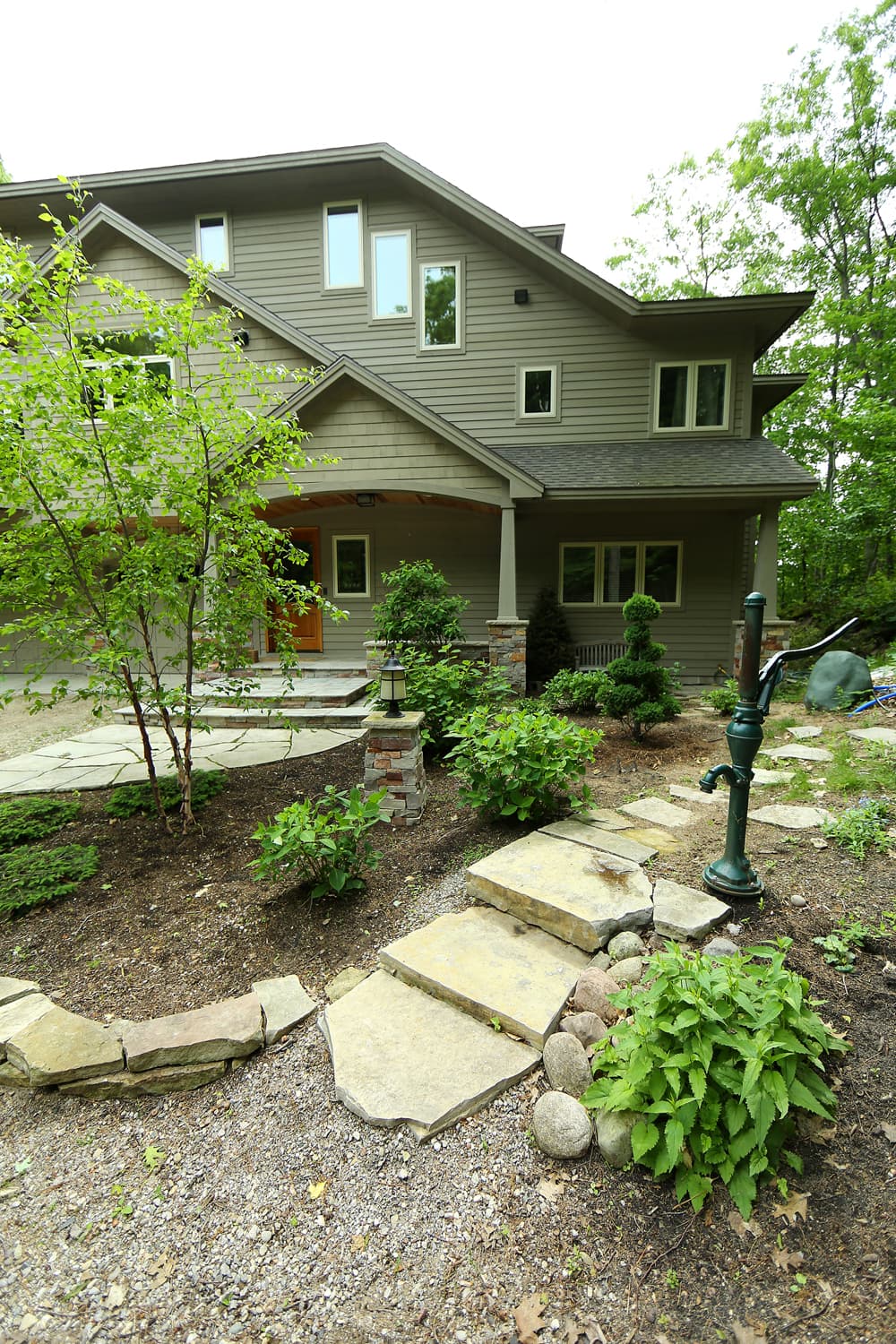 Flagstone walk and steps approaching a house.