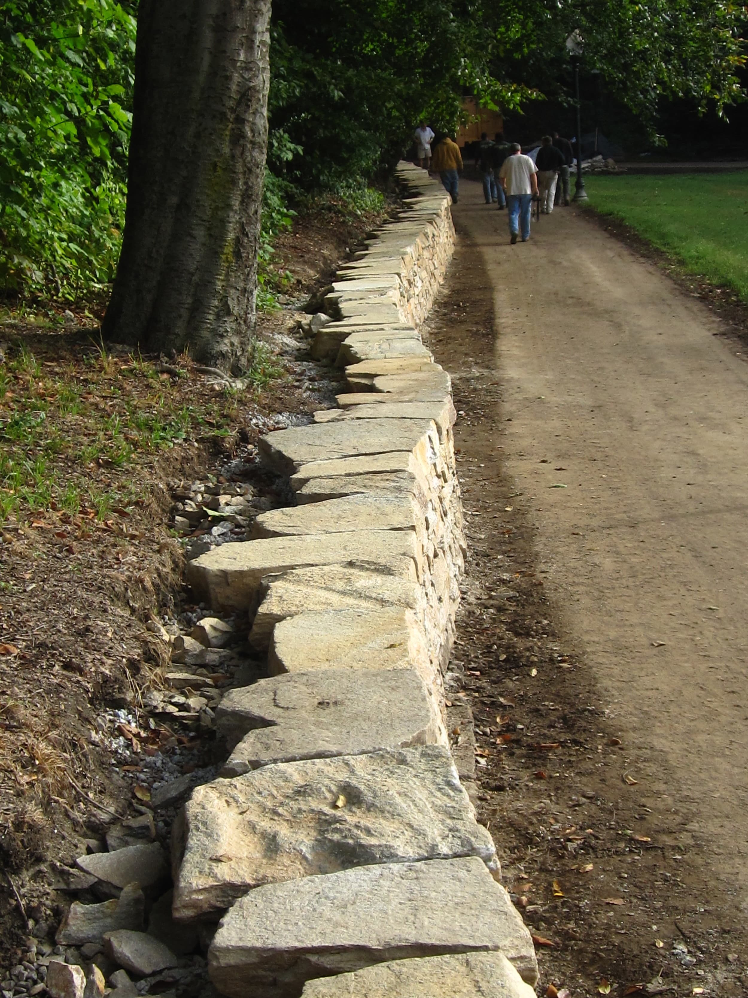 Long perspective of the rebuilt Wyman Park Dell wall.