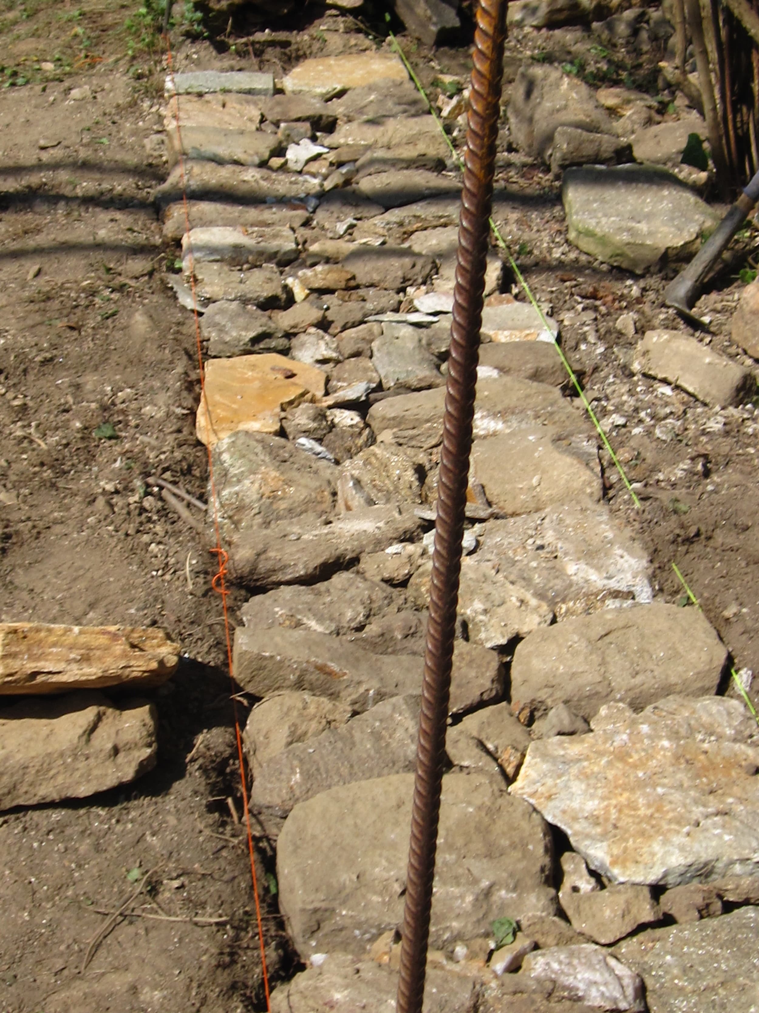 Capital stones along the top of the Wyman Park wall.