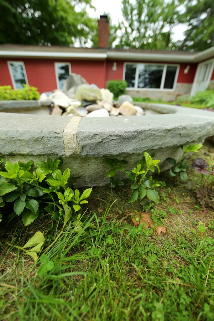 Close detail of the stone rim of the fountain.