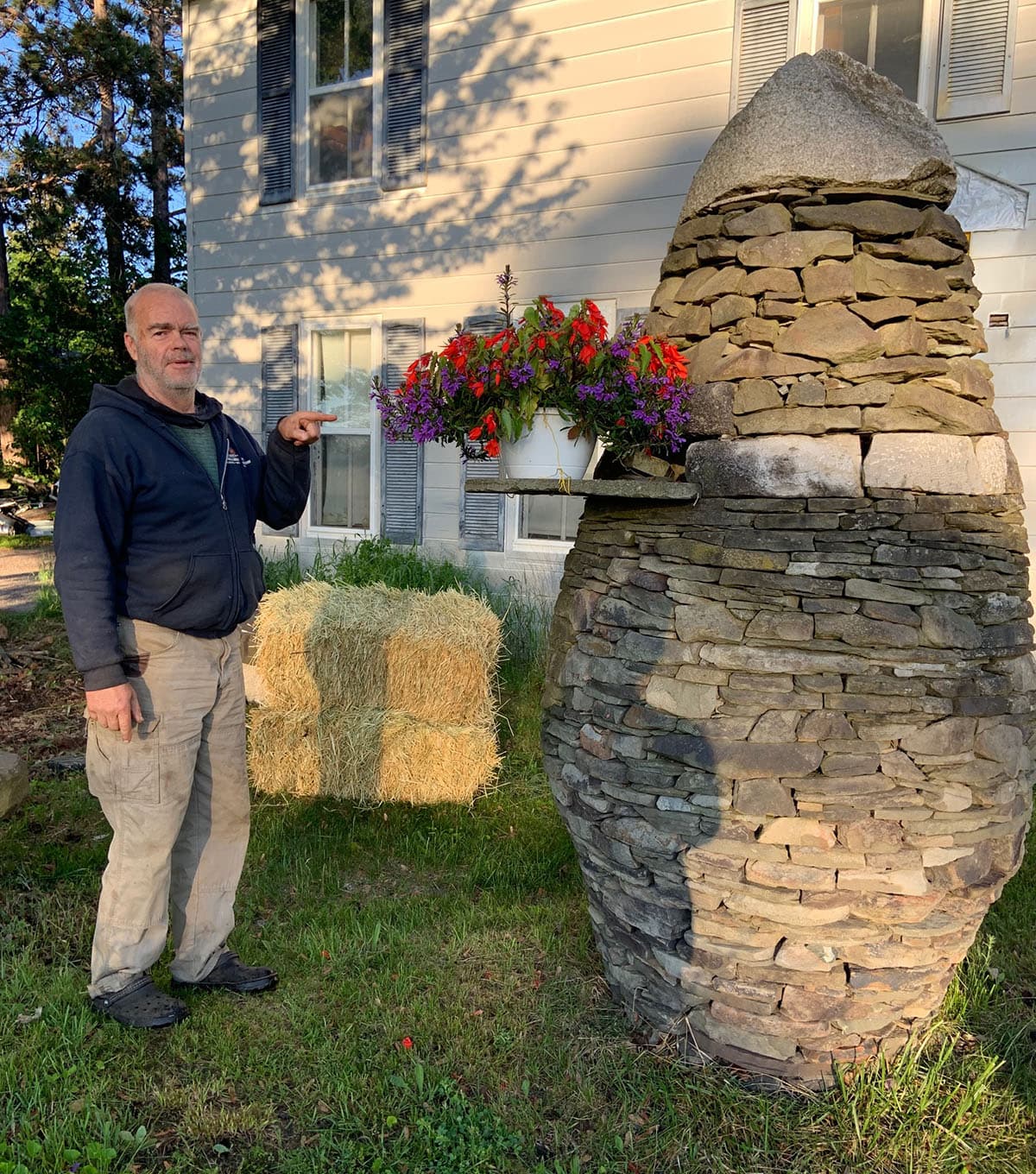 Michael Murphy beside one of his dry-stacked pinecone cairns.